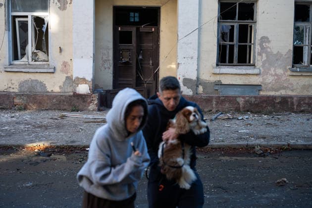 Ukraine says 12 people killed, 33 injured in Russia s overnight strike on Kyiv KYIV, UKRAINE - AUGUST 20: People, one carrying a dog, walk past a building with shattered windows following an overnight Russian attack on Kyiv, Ukraine, on August 20, 2026. Based on preliminary information provided by Kyiv Mayor Vitali Klitschko, at least 12 people were killed and 33 others wounded, while the Darnytskyi, Sviatoshynskyi and Solomianskyi districts sustained damage. Stringer Anadolu Kyiv Ukraine. Editorial use only. Please get in touch for any other usage.  Copyright: x2026xAnadoluxStringerx