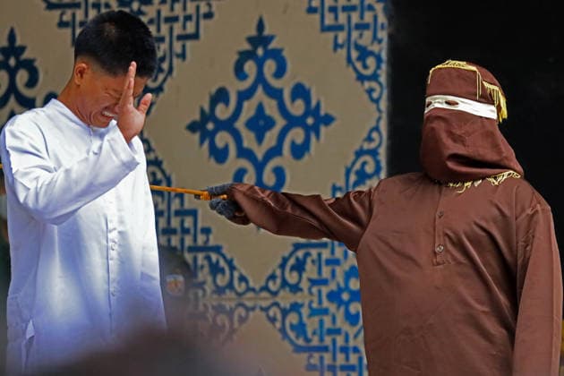 August 20, 2026, Banda Aceh, Aceh, Indonesia: A man endured pain while undergoing a public caning in Taman Sari, Banda Aceh, Aceh Province, Indonesia, on Thursday, August 20, 2026. The Banda Aceh Sharia Court sentenced 11 people to between 7 and 100 lashes for violating Islamic Sharia. Banda Aceh Indonesia - ZUMAs340 20260820_zip_s340_007 Copyright: xKhairuxSyukrillahx