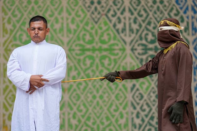 August 20, 2026, Banda Aceh, Aceh, Indonesia: One of four individuals who violated Sharia law by committing adultery underwent a punishment of 100 lashes at Bustanul Salatin Park in Banda Aceh, Aceh Province, Indonesia, on Thursday. Today, a total of 11 individuals convicted of violating the *Qanun Jinayat* (Islamic Criminal Code) underwent the punishment of caning. Among these 11 convicts, four were found guilty of the offense of adultery (*zina*) and were each sentenced to 100 lashes. Banda Aceh Indonesia - ZUMAi115 20260820_zip_i115_035 Copyright: xMuhammadxIqbalx