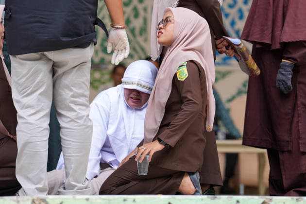 August 20, 2026, Banda Aceh, Aceh, Indonesia: An official assists a convict who is weak after receiving 100 lashes at Bustanul Salatin Park in Banda Aceh, Aceh Province, Indonesia, on Thursday. Today, 11 individuals convicted of violating the *Qanun Jinayat* (Islamic Criminal Code) underwent the punishment of caning. Among the 11 convicts, four were found guilty of *zina* (illicit sexual intercourse) and were each sentenced to 100 lashes. Banda Aceh Indonesia  - ZUMAi115 20260820_zip_i115_055 Copyright: xMuhammadxIqbalx