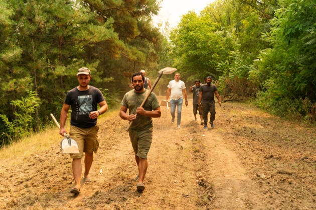 August 20, 2026, Grebenac, Vojvodina, Serbia: 2026820, Grebenac, Serbia - A massive wildfire that has been burning for weeks in the Deliblatska pescara, Special Nature Reserve has reached the village of Grebenac, as locals, firefighters, and military helicopters battle to bring the blaze under control. Local men armed with shovels walk down a dirt path into the forest to help extinguish the flames and prevent the fire from spreading further. Grebenac Serbia  - ZUMAd223 20260820_zip_d223_016 Copyright: xMarkoxDimicx