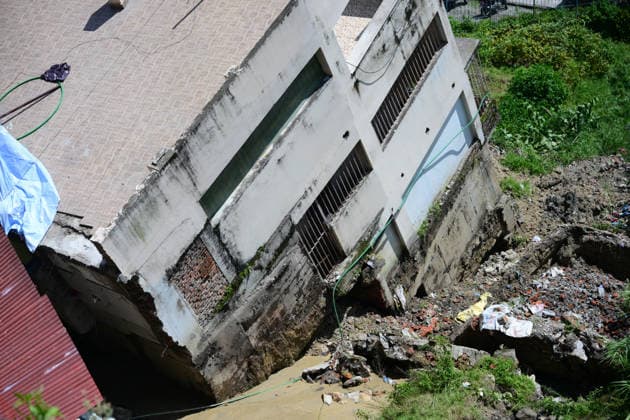 August 21, 2026, Kathmandu, Bagmati, Nepal: A two-and-a-half-storey house is seen collapsed after the ground beneath it sank due to rainfall in Bansbari, Kathmandu, Nepal, on August 21, 2026. No human casualties were reported in the incident. Kathmandu Nepal - ZUMAs330 20260821_zsp_s330_006 Copyright: xSafalxPrakashxShresthax