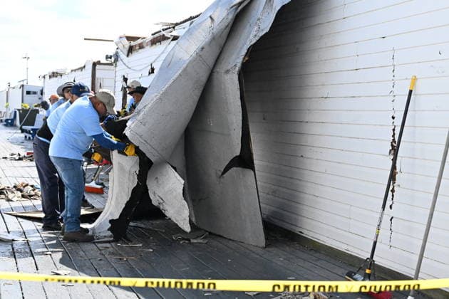 Tornado damage at Atlantic Beach in Long Island, New York NEW YORK, UNITED STATES - AUGUST 21: Emergency personnel and cleanup crews work amidst debris at the Sun and Surf Beach Club in Atlantic Beach, Long Island, New York, United States on August 21, 2026, following a rare tornado touchdown. The storm made landfall at approximately 7:11 p.m. on Thursday evening as a waterspout before moving ashore, destroying roughly 50 cabanas and tearing off roofs across the facility while nearly 100 people were present. Nassau County declared a state of emergency overnight as search teams swept the property, reporting only one minor injury, while the National Weather Service officially confirmed the tornadic event on Friday morning Kyle Mazza Anadolu  Copyright: x2026xAnadoluxKylexMazzax