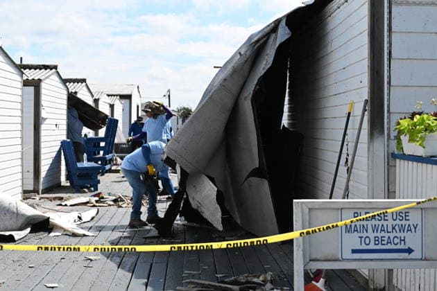 Tornado damage at Atlantic Beach in Long Island, New York NEW YORK, UNITED STATES - AUGUST 21: Emergency personnel and cleanup crews work amidst debris at the Sun and Surf Beach Club in Atlantic Beach, Long Island, New York, United States on August 21, 2026, following a rare tornado touchdown. The storm made landfall at approximately 7:11 p.m. on Thursday evening as a waterspout before moving ashore, destroying roughly 50 cabanas and tearing off roofs across the facility while nearly 100 people were present. Nassau County declared a state of emergency overnight as search teams swept the property, reporting only one minor injury, while the National Weather Service officially confirmed the tornadic event on Friday morning Kyle Mazza Anadolu  Copyright: x2026xAnadoluxKylexMazzax