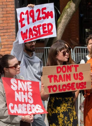 August 21, 2026, Manchester, United Kingdom: Protesters hold placards expressing their opinion during the demonstration. Unite Union members gather outside the UK government s Number 10 North regional headquarters at Heron House, 47 Lloyd Street, to protest against public funding waste and employment shortfalls in the NHS. Demonstrators carry placards saying Save NHS careers , 19.25 million wasted , and Highest mortality lowest staffing . The rally highlights a major jobs crisis facing newly qualified clinical psychologists and healthcare workers across the North West. Manchester United Kingdom - ZUMAs197 20260821_aaa_s197_075 Copyright: xGaryxRobertsx
