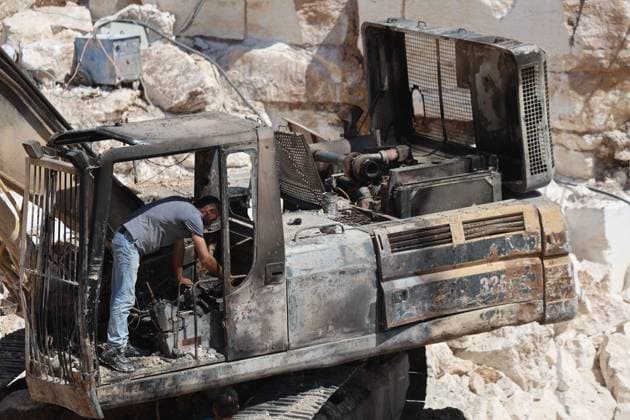 August 21, 2026, Hebron, Palestine, State of: AL-SAMU, HEBRON, WEST BANK, AUGUST 21, 2026: Traces of a settler arson attack targeting excavation machinery at an industrial rock and stone quarrying facility in Al-Samu, south of Hebron. Anti-Palestinian slogans are visible at the site following the attack. Hebron Palestine, State of - ZUMAq101 20260821_zna_q101_183 Copyright: xMosabxShawerx