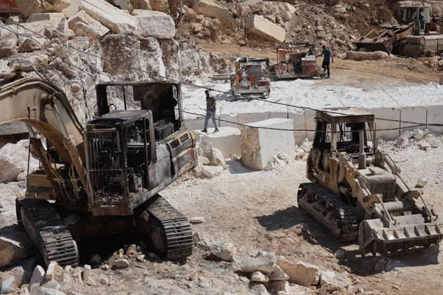 August 21, 2026, Hebron, Palestine, State of: AL-SAMU, HEBRON, WEST BANK, AUGUST 21, 2026: Traces of a settler arson attack targeting excavation machinery at an industrial rock and stone quarrying facility in Al-Samu, south of Hebron. Anti-Palestinian slogans are visible at the site following the attack. Hebron Palestine, State of - ZUMAq101 20260821_zna_q101_186 Copyright: xMosabxShawerx