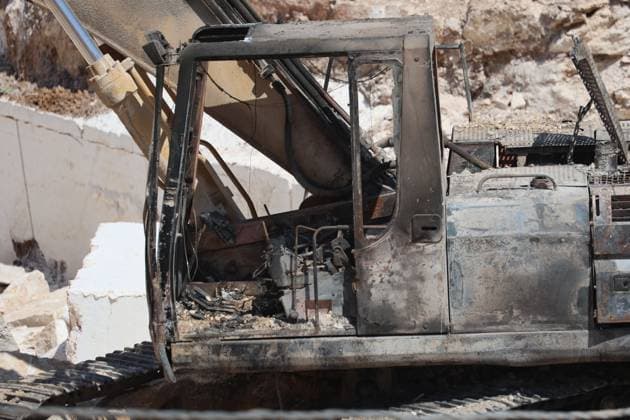 August 21, 2026, Hebron, Palestine, State of: AL-SAMU, HEBRON, WEST BANK, AUGUST 21, 2026: Traces of a settler arson attack targeting excavation machinery at an industrial rock and stone quarrying facility in Al-Samu, south of Hebron. Anti-Palestinian slogans are visible at the site following the attack. Hebron Palestine, State of - ZUMAq101 20260821_zna_q101_190 Copyright: xMosabxShawerx