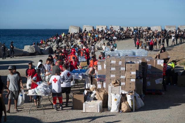 The humanitarian crisis in Ceuta continues. Red Cross members distribute food to migrants on a beach on August 21, 2026, in Ceuta, Spain. Ceuta continues to face a serious humanitarian crisis following the historic mass influx of more than 70,000 migrants who swam across the Tarajal on July 30 and 31. Although the police deployment and border reinforcement by by Moroccan authorities have managed to curb the influx, the autonomous city continues to face a serious humanitarian crisis, health, and security crises. AUGUST 21, 2026 TRAMPOLÍN BEACH MIGRANTS IMMIGRANTS RED CROSS MIGRATION CRISIS Ceuta Ceuta, Spain  Copyright: xMarcosxMorenox 7724968