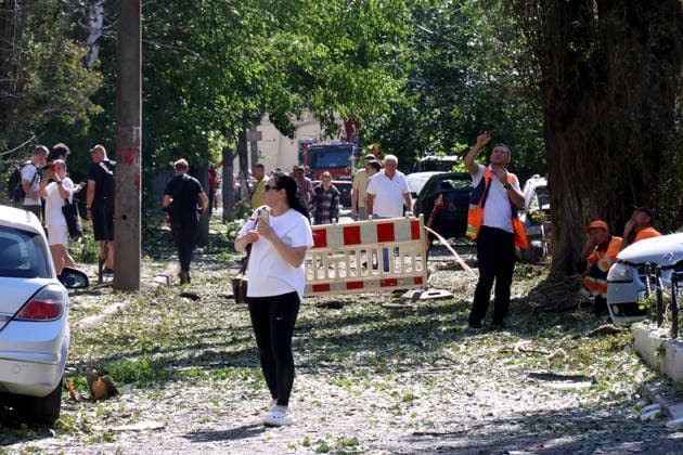 RECORD DATE NOT STATED Rescuers, municipal workers and local residents are on a street damaged by an overnight Russian attack on the capital in Kyiv’s Solomianskyi district, Ukraine, on August 20, 2026. Eight people were killed in the district as a result of Russia’s overnight massive combined attack. At least 16 multi-storey residential buildings were damaged, including a nine-storey building whose upper floors were destroyed, as well as a school, a kindergarten and premises of a children’s hospital. State Emergency Service rescuers and municipal workers are dismantling hazardous structures and clearing debris at the impact sites. An emergency assistance centre has been set up for those affected (Photo by Pavlo Bahmut Ukrinform) Aftermath of Russian strike in So  Copyright: xPavloxBahmutx