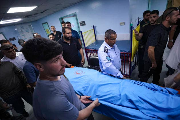 Farewell for 17 Year Old Karim Al Shalaldeh Palestinian mourners carry the shrouded body of Karim Sanad Shalaldeh through a crowded room during the funeral of 17-year-old Karim Sanad Shalaldeh in Sa ir, northeast of Hebron, in the occupied West Bank, on August 21, 2026. The Palestinian Health Ministry said Shalaldeh was killed by Israeli settler gunfire during an attack in the Khirbet Hamroush area of Sa ir that also wounded a 70-year-old Palestinian man; local reports said settlers set fire to a home, while the Israeli military said a security official opened fire after Palestinians threw stones at Israelis who were in the area without prior authorization. Hebron West Bank Palestinian Territories Copyright: xMosabxShawerx