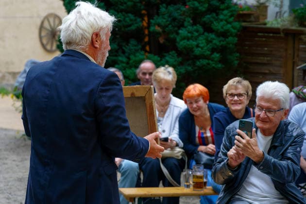Kunst Kultur Malerei Auktion 21.08.2026 Potsdam Landeshauptstadt Brandenburg Cafe Matschke Am Neuen Garten das Vintage-CafÃ Ausstellungen und Lesungen Galerie Cafe Schauspieler Jörg Schüttauf Schauspieler für Film, Fernsehen und Theater Versteigert Bilder des 1998 verstorbenen Potsdamer Künstlers Stefan Eisermann Foto Eberhard Thonfeld Potsdam Brandenurg GER *** Art, Culture, Painting, Auction, August 21, 2026, Potsdam, Capital of Brandenburg, Café Matschke, Am Neuen Garten, the vintage café, exhibitions and readings, gallery café, actor Jörg Schüttauf, actor for film, television, and theater. Paintings by Potsdam artist Stefan Eisermann, who died in 1998, are being auctioned. Photo: Eberhard Thonfeld, Potsdam, Brandenburg, GER