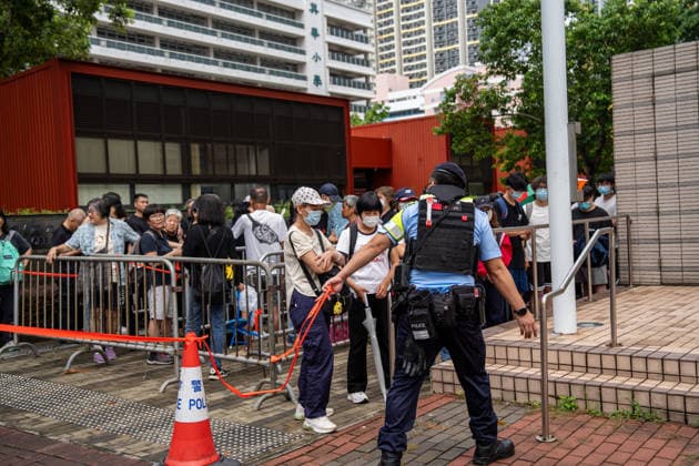 Hong Kong Court Verdit on Tiananmen Vigil Organizers Police officers stand guard next to people in line outside the West Kowloon Magistrates Courts before the court hands down the verdict on the Tiananmen Vigil Organizers on August 20, 2026 in Hong Kong. A Hong Kong court today founded the organizers of the previous annual Tiananmen Vigil in Victoria Park guilty of inciting subversion. (Photo by Vernon Yuen Nexpher Images) HONG KONG
