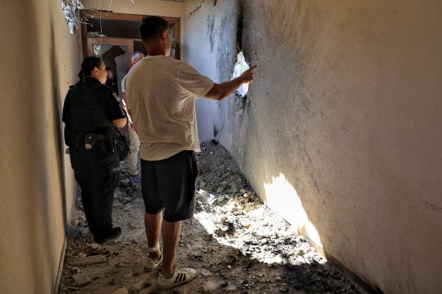 Workers and a police officer look at a hole in the wall at the training base of FC Chornomorets Odesa in the suburbs of Odesa, damaged by a Russian attack, Ukraine, August 22, 2026. The Liustdorf sports and recreation complex in Sovinion, a closed elite cottage village and prestigious leisure area in the south of Odesa near the Black Sea, sustained serious damage. No casualties among the team were reported. This is not the first case of targeted destruction of the club’s property. In February 2025, the training base was shelled for the first time, while on August 7, 2026, a missile strike hit the Chornomorets Stadium, the club’s main home arena in Odesa, injuring people. (Photo by Nina Liashonok Ukrinform) Russians attack training base of F  Copyright: xNinaxLiashonokx