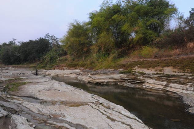 Rocky cliffs revealed after water level drop in Bogowonto River of Purworejo PURWOREJO, CENTRAL JAVA - AUGUST 22: Residents observe rocks and the rocky riverbed as the water level of the Bogowonto River drops during the dry season in Purworejo, Central Java, on August 22, 2026. The riverbed reveals unique wadas rock formations and natural rock carvings created by water erosion, resembling a miniature Grand Canyon stretching one kilometer. The river’s low water level is a result of the five-month-long dry season; normally, the Bogowonto River’s water level reaches five to six meters, covering the rocks and cliffs. Dasril Roszandi Anadolu Purworejo Indonesia. Editorial use only. Please get in touch for any other usage.  Copyright: x2026xAnadoluxDasrilxRoszandix
