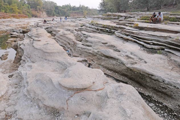 Rocky cliffs revealed after water level drop in Bogowonto River of Purworejo PURWOREJO, CENTRAL JAVA - AUGUST 22: Residents observe rocks and the rocky riverbed as the water level of the Bogowonto River drops during the dry season in Purworejo, Central Java, on August 22, 2026. The riverbed reveals unique wadas rock formations and natural rock carvings created by water erosion, resembling a miniature Grand Canyon stretching one kilometer. The river’s low water level is a result of the five-month-long dry season; normally, the Bogowonto River’s water level reaches five to six meters, covering the rocks and cliffs. Dasril Roszandi Anadolu Purworejo Indonesia. Editorial use only. Please get in touch for any other usage.  Copyright: x2026xAnadoluxDasrilxRoszandix
