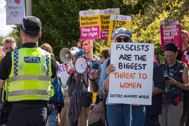 August 22, 2026, Gloucester, Gloucestershire, UK: Gloucester, UK. Counter protesters hold up a signsÃ¢â‚¬Â while a group called Gloucester Patriots protest outside the Ibis Hotel in Bristol where asylum seekers and migrants are being accommodated. Gloucester UK  - ZUMAl94_ 20260822_zaf_l94_006 Copyright: xSimonxChapmanx