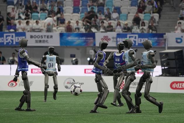 (260822) -- BEIJING, Aug. 22, 2026 -- Humanoid robots play football before the opening ceremony of the 2nd World Humanoid Robot Games in Beijing, capital of China, Aug. 22, 2026. ) (SP)CHINA-BEIJING-WORLD HUMANOID ROBOT GAMES-OPENING CEREMONY (CN) JuxHuanzong 