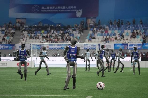 (260822) -- BEIJING, Aug. 22, 2026 -- Humanoid robots play football before the opening ceremony of the 2nd World Humanoid Robot Games in Beijing, capital of China, Aug. 22, 2026. ) (SP)CHINA-BEIJING-WORLD HUMANOID ROBOT GAMES-OPENING CEREMONY (CN) JuxHuanzong 