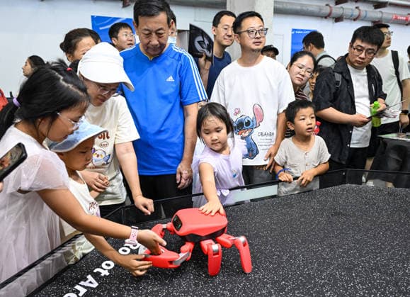 (260822) -- BEIJING, Aug. 22, 2026 -- People view a crab-shaped robot at the 2026 World Robot Conference in Beijing, capital of China, Aug. 22, 2026. The conference, which runs from Wednesday through Sunday, has drawn more than 300 exhibitors from 26 countries, with over 3,000 products on display, including more than 300 debuts. Many people visited the conference on Saturday, the first open day of the event. ) CHINA-BEIJING-WORLD ROBOT CONFERENCE (CN) ChenxYehua 