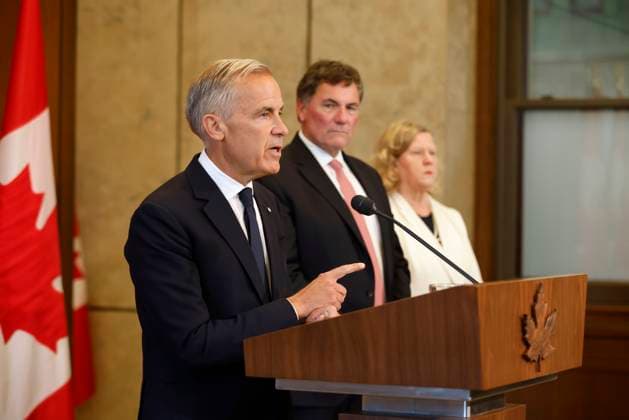 August 22, 2026, Ottawa, On, CANADA: Canada-U.S. Trade Minister Dominic LeBlanc and chief trade negotiator Janice Charette listen as Prime Minister Mark Carney speaks about Canada s response to new U.S. tariffs during a news conference on Parliament Hill in Ottawa on Saturday, Aug. 22, 2026. Ottawa CANADA  - ZUMAc35_ 20260822_zaf_c35_002 Copyright: xPatrickxDoylex