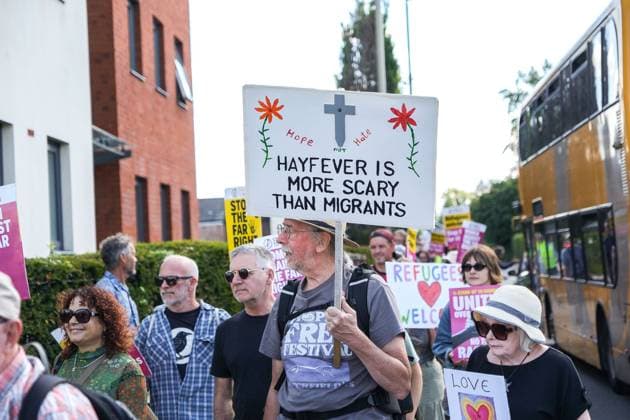 August 22, 2026, Gloucester, GB: GLOUCESTER, ENGLAND, AUGUST 22, 2026: Counter-protesters march through Gloucester carrying placards in support of refugees and opposing anti-immigration sentiment during demonstrations in the city. One placard reads, Ã¢â‚¬oeHayfever Is More Scary Than Migrants. Gloucester GB - ZUMAq101 20260822_zna_q101_053 Copyright: xMarcxLewisx