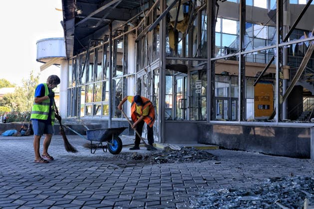 Municipal workers sweep away debris at the Rozdilna railway station building, damaged by a nighttime Russian drone attack, Odesa region, Ukraine, August 22, 2026. The drone carried out a targeted strike, flying directly into the station building. The blast wave and ensuing fire destroyed glazing and damaged internal structures and administrative offices. Passenger boarding and disembarkation on the platforms continues as normal. No injuries or fatalities were reported among passengers or railway staff. (Photo by Nina Liashonok Ukrinform) Russian drone hits railway station building in Odesa region  Copyright: xNinaxLiashonokx