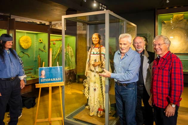 DEFA Schauspieler Gojko MitiÄ‡ im Karl May Museum Radebeul Die Rückkehr der Blackfoot-Frau: Namensweihe mit Gojko MitiÄ‡ im Karl May Museum Radebeul. Nach drei Jahren aufwändiger Restaurierung kehrt die beliebte Blackfoot-Frau nun am 22. August zurück in die Villa Bärenfett. Die Figur wurde auf den Namen Sitopanaki getauft, diesen Namen trug die Filmrolle der Frau welche die Partnerin von Mitic im Indianerfilm die Söhne der Großen Bärin trug. Radebeul Sachsen Deutschland *** DEFA Actor Gojko Mitic at the Karl May Museum in Radebeul: The Return of the Blackfoot Woman—A Naming Ceremony with Gojko Mitic at the Karl May Museum in Radebeul After three years of extensive restoration, the beloved Blackfoot woman is now returning to Villa