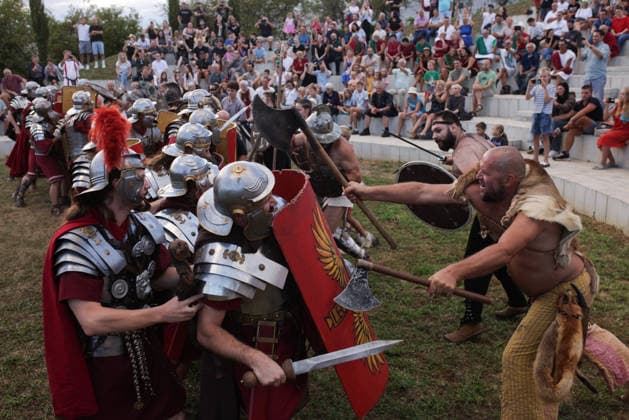 (260822) -- PTUJ, Aug. 22, 2026 -- Participants dressed as Roman soldiers and barbarians demonstrate a battle during the Roman Games Festival in Ptuj, Slovenia, Aug. 22, 2026. The 19th edition of the Roman Games festival kicked off on Friday in Ptuj and will last till Aug. 23. (Photo by Xinhua) SLOVENIA-PTUJ-ROMAN GAMES FESTIVAL ZeljkoxStevanic 