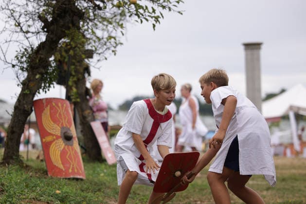 (260822) -- PTUJ, Aug. 22, 2026 -- Boys dressed in Roman costumes play during the Roman Games Festival in Ptuj, Slovenia, Aug. 22, 2026. The 19th edition of the Roman Games festival kicked off on Friday in Ptuj and will last till Aug. 23. (Photo by Xinhua) SLOVENIA-PTUJ-ROMAN GAMES FESTIVAL ZeljkoxStevanic 