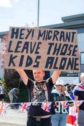 August 22, 2026, Gloucester, GB: GLOUCESTER, ENGLAND, AUGUST 22, 2026: An activist holds a sign reading Ã¢â‚¬oeRefugees WelcomeÃ¢â‚¬Â while walking through a residential street during a protest in Gloucester. The demonstration was held amid debate over the accommodation of migrants in local hotels. Gloucester GB - ZUMAq101 20260822_zna_q101_118 Copyright: xEthanxFowlerx