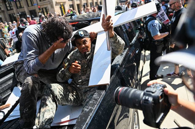 August 22, 2026, Minneapolis, Minnesota, USA: Supporters of far-right influencer, Jake Lang ride in the back of the truck he was in before he moved to the passenger seat while riding in front of Minneapolis City Hall on the sidewalk through a group of protestors of the action on Saturday, August 22nd, 2026. Minneapolis USA - ZUMAd171 20260822_znp_d171_009 Copyright: xSethxDonovanx