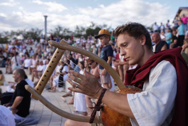 News Bilder des Tages #2 (260823) -- BEIJING, Aug. 23, 2026 -- A participant dressed in Roman costume plays the lyra during the Roman Games Festival in Ptuj, Slovenia, Aug. 22, 2026. The 19th edition of the Roman Games festival kicked off on Friday in Ptuj and will last till Aug. 23. (Photo by Xinhua) XINHUA PHOTOS OF THE DAY ZeljkoxStevanic 