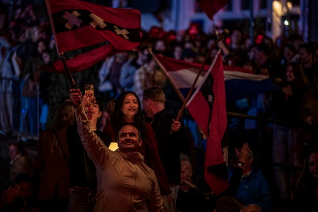 August 22, 2026, Amsterdam, North Holland, The Netherlands: Audience members wave the flag of the city of Amsterdam as musicians perform the song De Stad Amsterdam (The City of Amsterdam). 22 August 2026, in Amsterdam, the Netherlands. The 44th edition of the Prinsengrachtconcert takes place on a floating stage on the Prinsengracht in front of Hotel Pulitzer, the largest free open-air classical music concert in the Netherlands. Amsterdam The Netherlands - ZUMAp202 20260822_zip_p202_036 Copyright: xJamesxPetermeierx