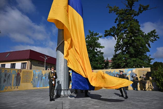 National Flag Day of Ukraine in Lviv LVIV, UKRAINE - AUGUST 23: Ukrainian servicemen hold a large national flag during a National Flag Day ceremony in Lviv, Ukraine, on August 23, 2026. Due to the ongoing Russian-Ukrainian War, celebrations were limited to a ceremonial raising of the Ukrainian flag on the city s highest flagpole with the participation of soldiers from various branches of the armed forces. Participants also observed a minute of silence for those killed, sang the Ukrainian national anthem, and listened to patriotic and folk songs performed by a military orchestra. Michael Sorrow Anadolu Lviv Ukraine. Editorial use only. Please get in touch for any other usage.  Copyright: x2026xAnadoluxMichaelxSorrowx