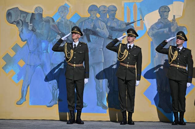 National Flag Day of Ukraine in Lviv LVIV, UKRAINE - AUGUST 23: Ukrainian servicemen salute during a National Flag Day ceremony in Lviv, Ukraine, on August 23, 2026. Due to the ongoing Russian-Ukrainian War, celebrations were limited to a ceremonial raising of the Ukrainian flag on the city s highest flagpole with the participation of soldiers from various branches of the armed forces. Participants also observed a minute of silence for those killed, sang the Ukrainian national anthem, and listened to patriotic and folk songs performed by a military orchestra. Michael Sorrow Anadolu Lviv Ukraine. Editorial use only. Please get in touch for any other usage.  Copyright: x2026xAnadoluxMichaelxSorrowx