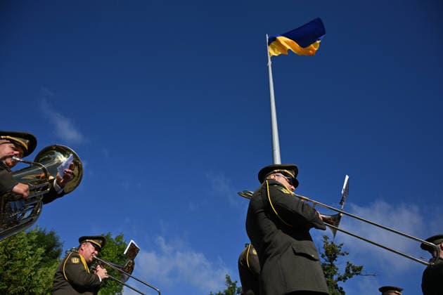 National Flag Day of Ukraine in Lviv LVIV, UKRAINE - AUGUST 23: Celebration of the National Flag Day of Ukraine during the Russian-Ukrainian War in Lviv, Ukraine on August 23, 2026. Due to the war, only the ceremonial raising of the Ukrainian flag on the highest flagpole in the city with the participation of soldiers from various branches of the armed forces took place. People also honored the fallen with a minute of silence, sang the Ukrainian anthem, and a military orchestra played several patriotic and folk songs. Michael Sorrow Anadolu Lviv Ukraine. Editorial use only. Please get in touch for any other usage.  Copyright: x2026xAnadoluxMichaelxSorrowx