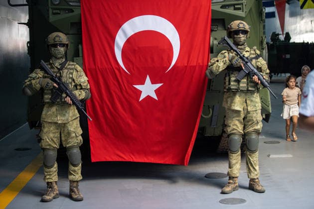 TEKNOFEST Blue Homeland KOCAELI, TURKIYE - AUGUST 23: Turkish soldiers stand guard beside a Turkish flag and an armored military vehicle displayed during TEKNOFEST Blue Homeland at the Golcuk Naval Shipyard Command in Kocaeli, Turkiye, on August 23, 2026. TCG Sancaktar carries out military missions including amphibious operations and mine-laying, and can also serve as a hospital, logistics support and evacuation ship in disaster zones. The event, organized under the leadership of the Turkish Ministry of National Defense and the Turkish Technology Team Foundation (T3 Foundation), with Anadolu serving as its Global Communication Partner, continues on its final day. Ibrahim Yozoglu Anadolu Kocaeli Turkey. Editorial use only. Please get in to  Copyright: x2026xAnadoluxIbrahimxYozoglux
