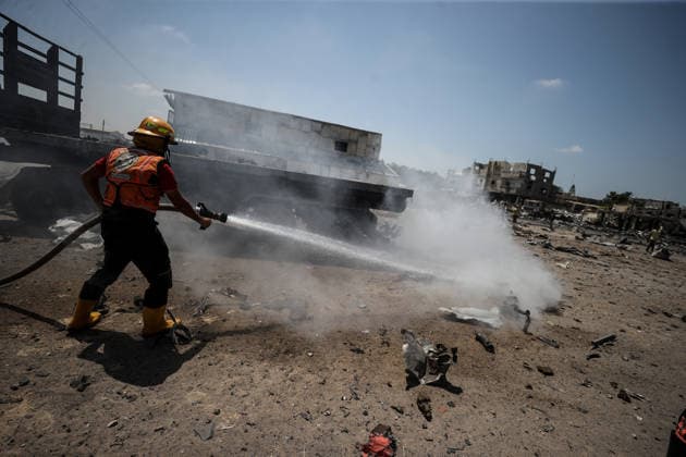 Israeli attacks on Gaza continue despite ceasefire GAZA STRIP, GAZA, PALESTINE - AUGUST 23: A firefighter intervenes to extinguish several vehicles that caught fire following an Israeli airstrike that destroyed several homes and tents where displaced Palestinians were staying in Zuvayda, Gaza Strip, Palestine, on August 23, 2026. Ali Jadallah Anadolu Gaza Strip Gaza. Editorial use only. Please get in touch for any other usage.  Copyright: x2026xAnadoluxAlixJadallahx