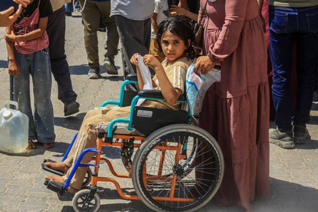 Patients and injured Palestinians in Gaza protest for medical treatment abroad KHAN YUNIS, GAZA, PALESTINE - AUGUST 23: A girl in a wheelchair is seen as Palestinian patients and injured people gather outside Nasser Hospital to protest and demand permission to leave the Gaza Strip for medical treatment abroad in Khan Yunis, southern Gaza, Palestine, on August 23, 2026. Demonstrators say the health conditions of patients who have been waiting for a long time are deteriorating due to Israel allowing only limited passage through border crossings, and call for permission to leave Gaza for medical treatment. Abed Rahim Khatib Anadolu Khan Yunis Gaza. Editorial use only. Please get in touch for any other usage.  Copyright: x2026xAnadoluxAbedxRahimxKhatibx