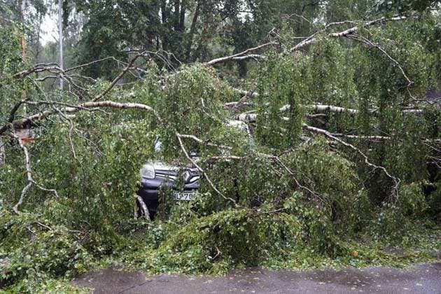 August 23, 2026, Riga, Latvija: The aftermath of a powerful storm is seen in Riga, Latvia, Aug. 23, 2026. Fallen and uprooted trees are scattered across residential areas, damaging parked cars, blocking roads and walkways, and posing a threat to nearby buildings. The storm, which swept across Latvia on Saturday evening and overnight, caused widespread damage across the country, with Riga recording the highest number of reports of storm-related incidents. As of Sunday morning, emergency services had received nearly 1,900 reports of damage caused by strong winds nationwide. Riga Latvija  - ZUMAp305 20260823_zip_p305_017 Copyright: xEdijsxPalensx