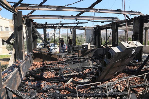August 23, 2026, Nablus, West Bank, Palestin: Palestinians inspect a house that was set on fire following an attack by a group of Jewish settlers in the village of Osarin, south of Nablus in the West Bank. The settlers attacked homes, torched a Palestinian car in the early morning hours, and spray-painted Hebrew slogans on walls calling for revenge against Palestinians. Nablus Palestin - ZUMAs197 20260823_aaa_s197_022 Copyright: xNasserxishatyehx