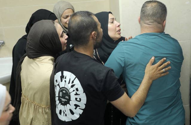 Palestinian-Israeli conflict in Nablus, Palestine - 23 Aug 2026 (EDITOR S NOTE; Images depict death) Relatives and friends of a 14-year-old Palestinian boy, Islam Ajouri weep over his body at the morgue of Rafidia Hospital. Ajouri was killed during an Israeli military operation in the Askar refugee camp. Israeli forces raided Palestinian shops and homes. A Palestinian medical source reported that a 15-year-old boy was killed by Israeli fire and two others were wounded during stone-throwing clashes in the Askar refugee camp. Nablus Palestine Copyright: xNasserxishatyehx xSOPAxImagesx Nishtayeh190