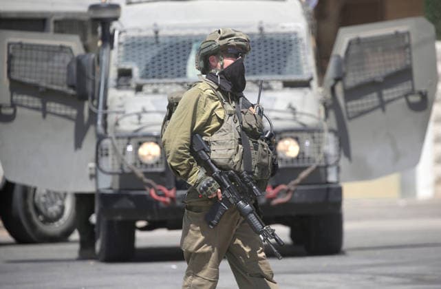 August 23, 2026, Nablus, West Bank, Palestine: An Israeli soldier guards military vehicles during a military operation in the Askar refugee camp. Ajouri was killed during an Israeli military operation in the Askar refugee camp. Israeli forces raided Palestinian shops and homes. A Palestinian medical source reported that a 15-year-old boy was killed by Israeli fire and two others were wounded during stone-throwing clashes in the Askar refugee camp. Nablus Palestine - ZUMAs197 20260823_aaa_s197_112 Copyright: xNasserxishatyehx