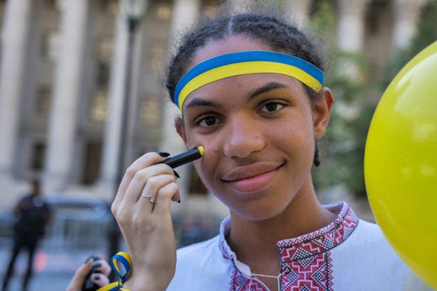 August 23, 2026, New York, New York, USA: Painted face flag at the Annual Ukrainian Independence March celebrating freedom from foreign domination. A large crowd .marched from Foley Square down Broadway to Bowling Green in Lower Manhattan commemorating .Ukraine freedom from Soviet Union oppression on Aujust 24. Carrying the blue and yellow flag of Ukraine as well as the US flag they carried the message of fighting back against Russia trying to continue their colonial empire. Ukraine is standing strong..Standing for democracy not tyranny. New York USA  - ZUMAh156 20260823_znp_h156_005 Copyright: xMiloxHessx