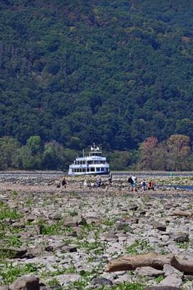 23.8.2026 Dürre Der extrem niederige Wasserstand des Rhein. Große Teile des Binger Lochs an de Nahemündung liegen trocken. Die Menschen spazieren dort wo sonst meterhoch das Wasser fließt. Die Fahrrinne für die Schifffahrt ist nur eingeschränkt nutzbar. Bingen Rhein Rheinland Pfalz Deutschland *** August 23, 2026 Drought The water level of the Rhine is extremely low. Large parts of the Binger Loch at the mouth of the Nahe are dry. People are walking where the water would normally flow meters high. The shipping channel is only partially usable. Bingen, Rhine, Rhineland-Palatinate, Germany