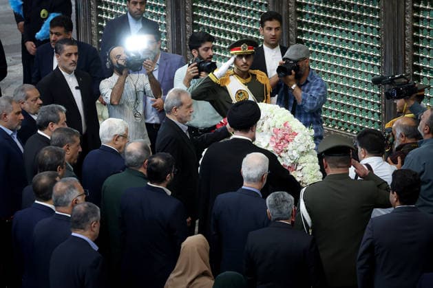 President Masoud Pezeshkian (C) attends an event to mark the first day of the Government Week at the mausoleum of Ayatollah Ruhollah Khomeini, the founder of the Islamic Republic of Iran, in Tehran, Iran on August 23, 2026. Iranian President Masoud Pezeshkian declared that no power will be able to force the Iranian people into surrender. He dismissed claims that sanctions would turn Iran into another Venezuela, saying that has not happened. He stressed the need to begin conserving gasoline consumption through government measures, including a plan to reduce the number and fuel use of government vehicles.  IRN2026082312 IranianxPresidency