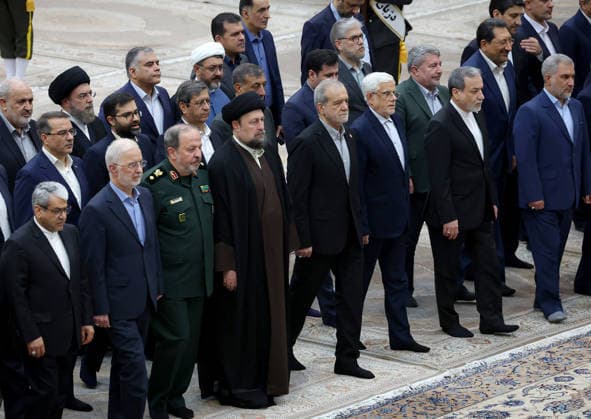 President Masoud Pezeshkian (C) attends an event to mark the first day of the Government Week at the mausoleum of Ayatollah Ruhollah Khomeini, the founder of the Islamic Republic of Iran, in Tehran, Iran on August 23, 2026. Iranian President Masoud Pezeshkian declared that no power will be able to force the Iranian people into surrender. He dismissed claims that sanctions would turn Iran into another Venezuela, saying that has not happened. He stressed the need to begin conserving gasoline consumption through government measures, including a plan to reduce the number and fuel use of government vehicles.  IRN2026082314 IranianxPresidency