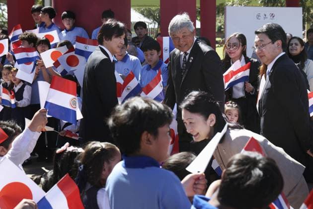 Japan crown prince, crown princess in Paraguay Japan s Crown Prince Fumihito (L) and Crown Princess Kiko are greeted by children in Yguazu on Aug. 23, 2026, during their official trip to Paraguay to mark 90 years of Japanese immigration to the South American country. (Pool photo)  A14AA0005626572P