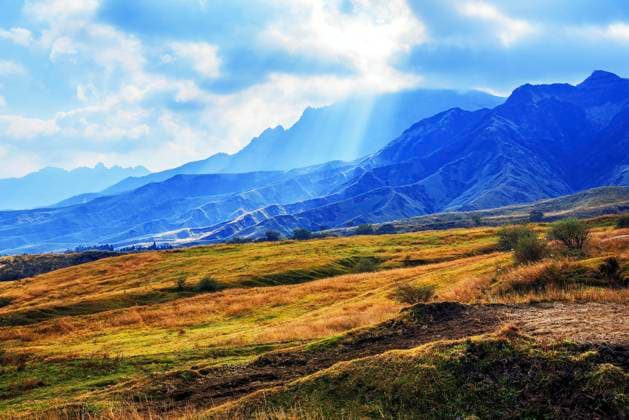 Sun-rays penetrate clouds and illuminate hills during autumn in Aso, Kumamoto Prefecture, Kyushu, Japan Copyright: EngxKiatxLeong 1390-789